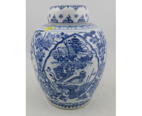 A Kangxi vase and cover, decorated in blue and white with foliage and reserved panels, height 12.5ins&nbsp;Condition Report: 