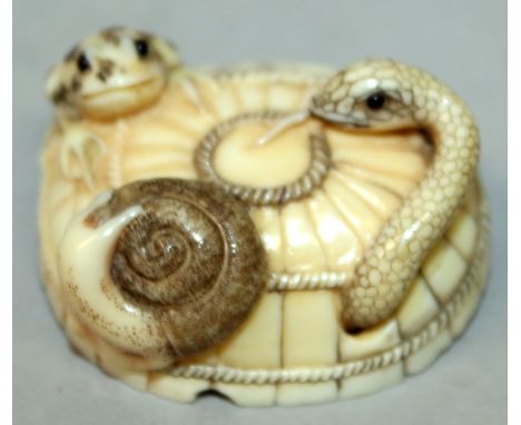 AN UNUSUAL EARLY 20TH CENTURY SIGNED JAPANESE IVORY NETSUKE, of a snake, toad and a snail, on top of a covered snake basket, 