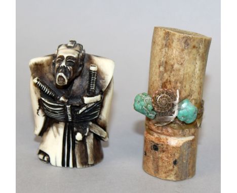 A STAINED IVORY NETSUKE OF A SAMURAI, 2in high; together with a bone section wrapped with a shell and two pieces of hardstone