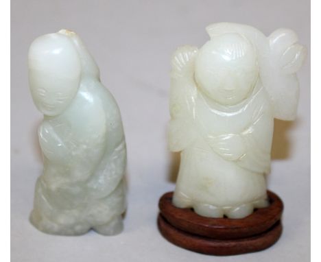 TWO SMALL 19TH CENTURY CHINESE CELADON JADE FIGURES, one of the figures with a good quality fitted wood stand, 2.2in & 2.4in 