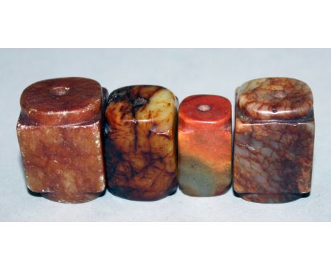 A GROUP OF FOUR JADE & SOAPSTONE CONG BEADS, the largest 1.1in high. (4)