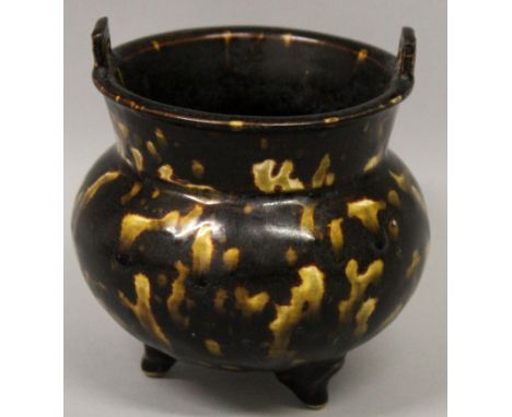 A CHINESE JIZHOU KILN CERAMIC TRIPOD CENSER, splashed in a translucent golden yellow glaze in imitation of tortoiseshell, 4.1