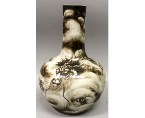 AN UNUSUAL CHINESE DRAGON BOTTLE VASE, the sides decorated in brown enamel with a dragon amidst swirling clouds, the base wit