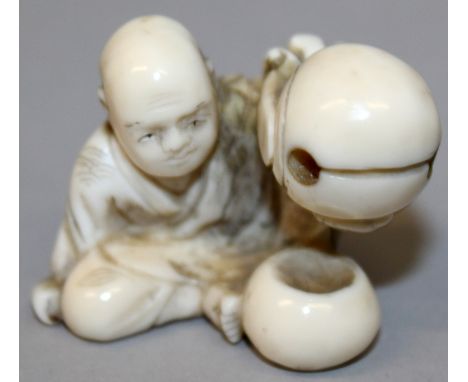 A SIGNED JAPANESE MEIJI PERIOD IVORY NETSUKE OF A SEATED BOY, holding aloft a large bell, the base with an engraved signature