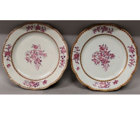 A PAIR OF 18TH CENTURY CHINESE QIANLONG PERIOD FAMILLE ROSE PORCELAIN PLATES, with barbed rims, each painted in mainly puce e