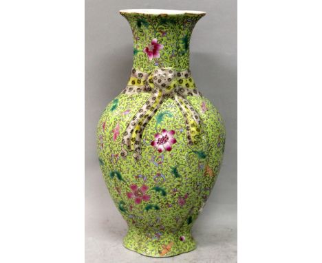 A CHINESE LIME-GREEN GROUND FAMILLE ROSE PORCELAIN VASE, the sides of the quatrefoil-section body decorated with bats and scr