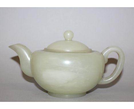 A FINE QUALITY 18TH/19TH CENTURY CHINESE CELADON JADE TEAPOT & COVER, the elegantly formed body with paler inclusions, 7.75in