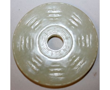 A GOOD 18TH/19TH CENTURY CHINESE CELADON JADE BI DISC, carved in low relief to one side with the Eight Trigrams, the reverse 