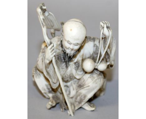 A GOOD JAPANESE MEIJI PERIOD IVORY OKIMONO OF A BEARDED SAGE, squatting, and in the company of a boy, the sage holding a gour