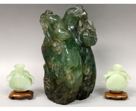 AN EARLY 20TH CENTURY CHINESE GREEN BOWENITE MODEL OF TWO PHOENIX, perched on rockwork, 8in high; together with a small pair 