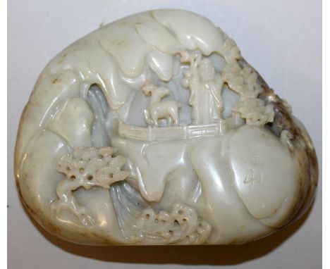 A CHINESE JADE BOULDER, carved in the form of Shou Lao and a deer in a rocky landscape, the side incised with a two-character