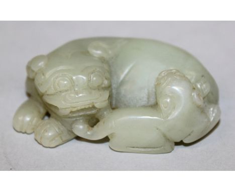 A CHINESE CELADON JADE MODEL OF A BUDDHISTIC LION & ITS PUP, 2.3in long.