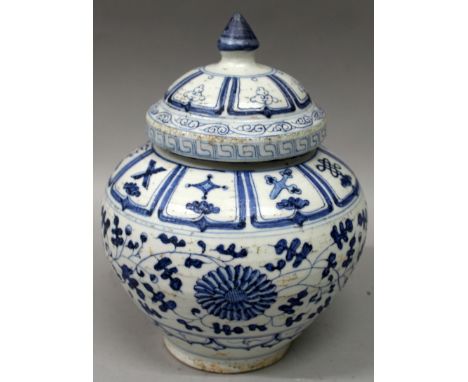 A CHINESE MING STYLE BLUE & WHITE PORCELAIN JAR & COVER, decorated with leaf and scroll stemmed flowerheads between formal bo