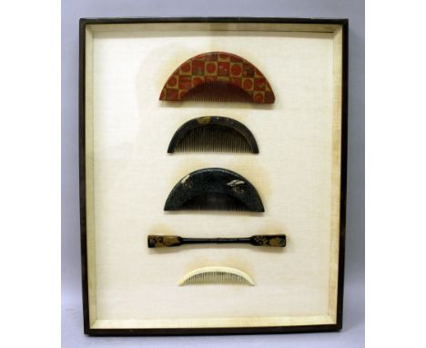 A METAL FRAMED & MOUNTED COLLECTION OF FOUR JAPANESE MEIJI PERIOD COMBS & A HAIR ORNAMENT, the ornament of lacquered wood, on