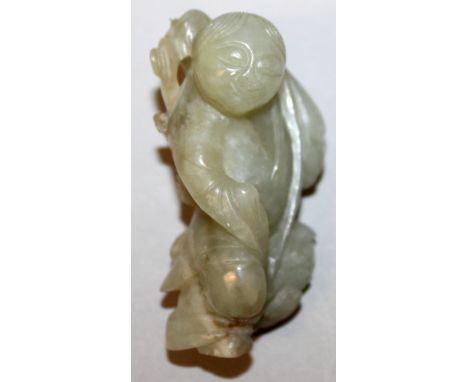A 19TH/20TH CENTURY CHINESE CELADON JADE FIGURE OF A STANDING BOY, with a three-legged toad supported on his shoulders, 2.25i