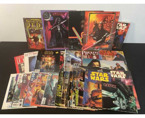 A selection of STAR WARS comics and magazines, including Official Collectors Souvenir Brochure, Star Wars Weekly, and some si