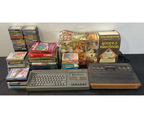 A group of retro gaming computers and games comprising an Acorn Electron in original box, a Sinclair ZA Spectrum 2 unboxed, a