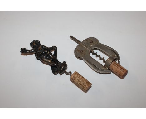 A large bronze cherub corkscrew, 17cm overall; and an antique Magic Lever cork draw corkscrew