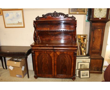 A Victorian quality carved figured mahogany chiffonier the top above two shelves supported by turned columns and carved swans