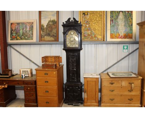An antique carved oak cased grandfather clock, the brass dial inscribed "Baddely or Brighton"