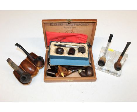A Pukeberg Sweden glass pipe rest; a carved wooden pipe rest and King Edward cigar box all containing various pipes 