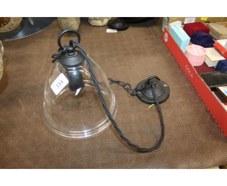 A Jim Lawrence black pendant light fitting with glass shade in the form of a bell