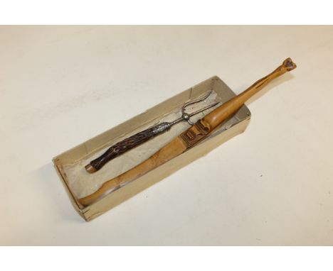 A hoof handled page turner and a horn handled toasting fork