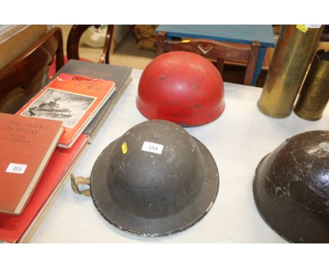 A WWII Dispatch riders helmet with a British Army helmet