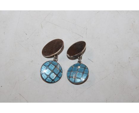 A pair of silver and enamel decorated cuff-links 
