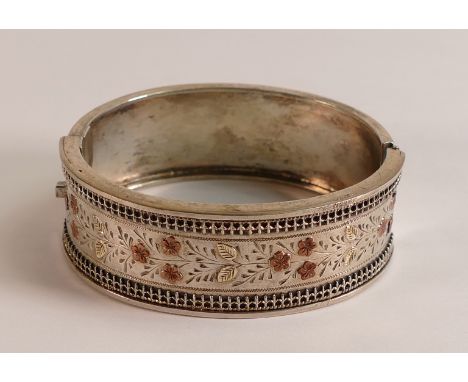 Silver bangle with yellow metal floral decoration,32.3g. 