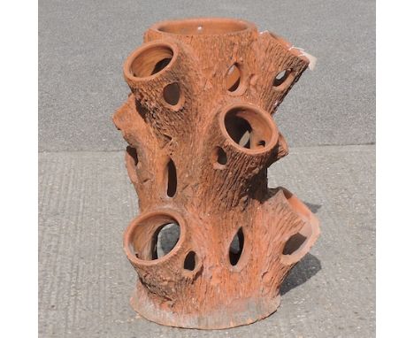 A terracotta planter, in the form of a tree trunk, 78cm tall