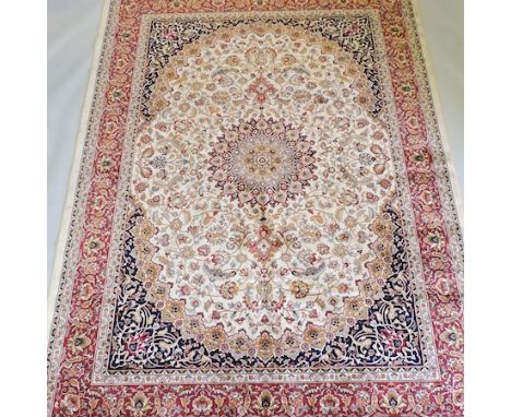 A Keshan carpet, with a central medallion, on a cream ground, 280 x 200cm