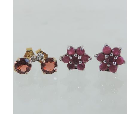 A pair of garnet and diamond earrings, together with a pair of ruby earrings, boxed 