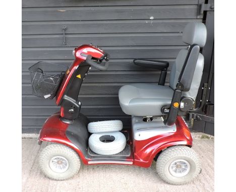 A red Shoprider electric mobility scooter, with charger, 126cm overall