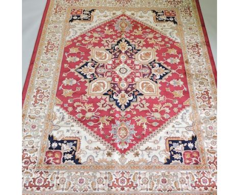 A Heriz carpet, with a central medallion, on a cream ground, 280 x 200cm