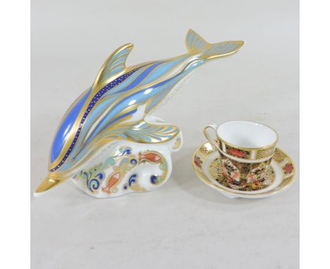 A Royal Crown Derby model of a dolphin, with stopper, 9cm tall together with a miniature teacup and saucer