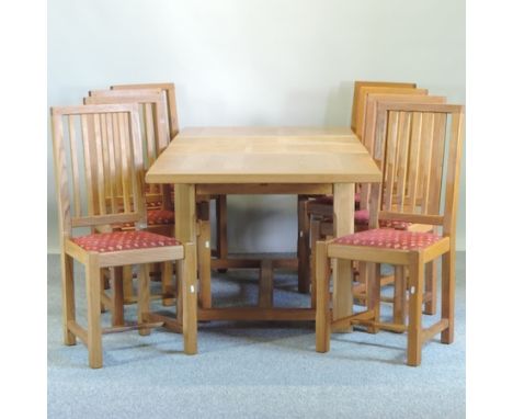 A light oak dining table, together with a set of eight chairs 