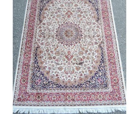 A Keshan carpet, with a central medallion, and floral medallions, on a cream ground, 240 x 160cm