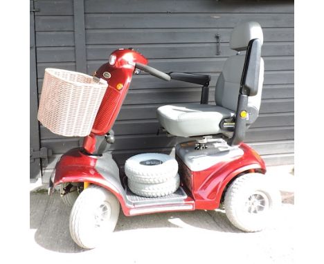 A red Shoprider, electric mobility scooter, with charger, 121cm overall