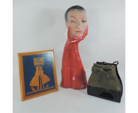 A Christian Dior advertising plaster head, 56cm tall, together with a handbag and a Burberry advertising plaque