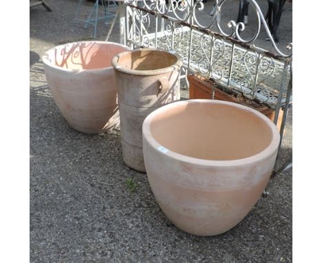 A pair of terracotta garden planters, 43cm tall, together with a trough planter and a cylinder planter