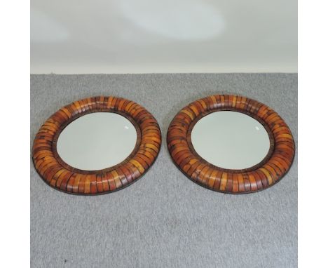 A pair of modern circular wall mirrors, 80cm diameter, together with a wicker hamper