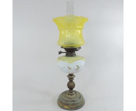 A Victorian brass oil lamp, with an etched yellow glass reservoir and shade, 59cm tall