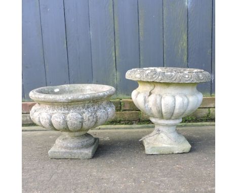 A reconstituted stone, garden planter, with fluted decoration, 38cm tall, together with another smaller 