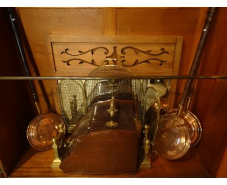 Three copper warming pans, an oak over mantle mirror, brass fireguard, a mahogany and brass coal bin and a pair of brass fire