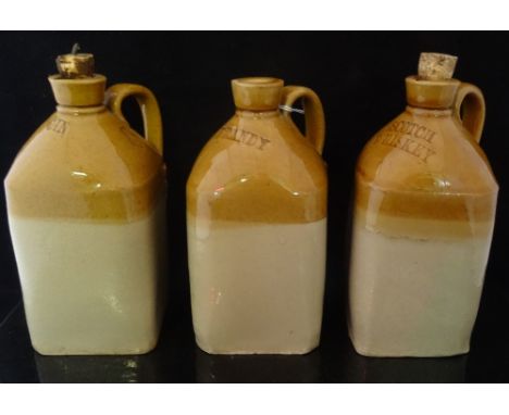 A set of three mid-19th century stoneware spirit decanters, labelled 'Brandy', 'Gin' and 'Scotch Whiskey', each of square for