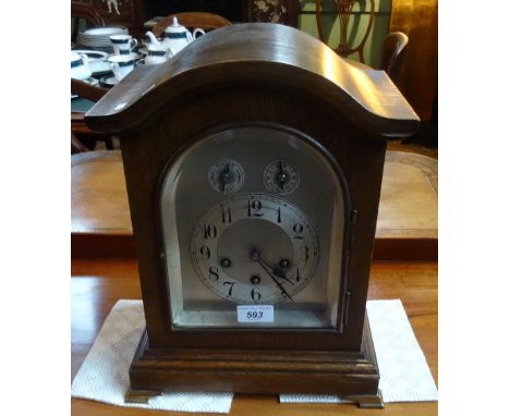 A 20th century oak cased chiming bracket clock, the silvered dial bearing Arabic numerals, the whole on stepped rectangular b