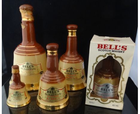 A collection of five Bell's Scotch Whisky decanters, each in Wade bell shaped containers, one with original box, various size