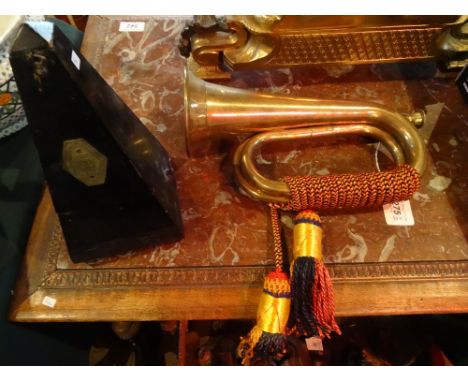 A brass military bugle with tassels, together with a Swiss made metronome of typical form.