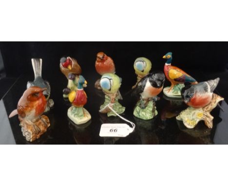 A collection of ten Beswick ceramic birds, to include: Bluetits, Bullfinch, Stonechat and others. Condition Report: Small chi